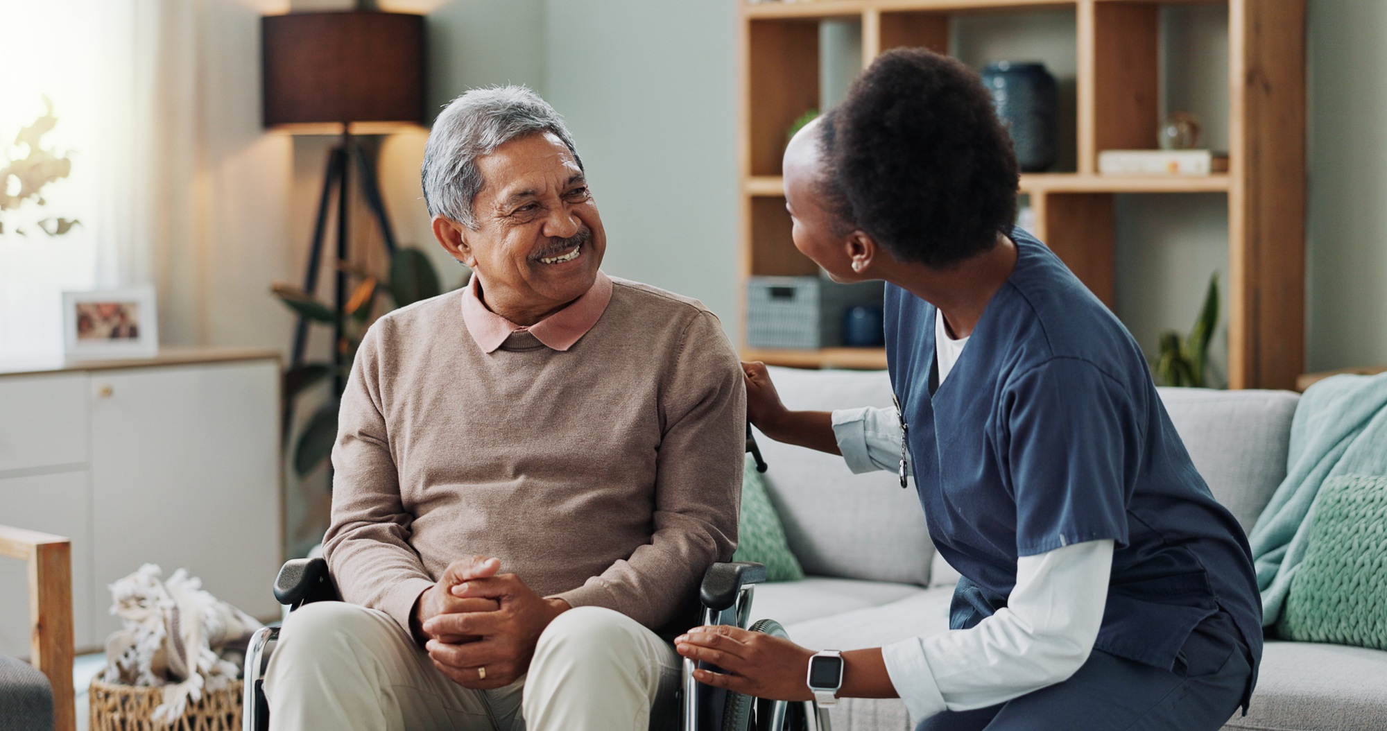 Senior, man and caregiver with talking or support in nursing home for mobility, injury healing and